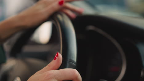 Woman-turns-steering-wheel-of-car-to-sides-moving-fingers