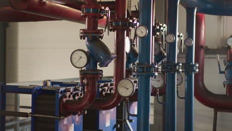 Pipes-with-pressure-meters-connected-to-pumps-in-boiler-room