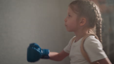Determined-girl-punches-person-picture-on-boxing-bag