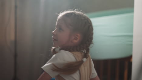 Little-girl-with-back-brace-punches-swinging-boxing-bag