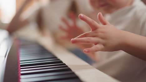 Small-boy-hand-presses-piano-keys-learning-simple-theme