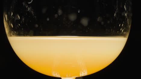 Sweet-orange-juice-with-alcohol-poured-in-transparent-glass
