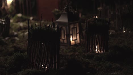 Decorations-for-the-holiday-small-houses-in-the-grass-illuminated-by-lamps-at-night