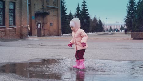 Cinemagraph-little-child-is-jumping-in-a-puddle-leaving-a-lot-of-spray