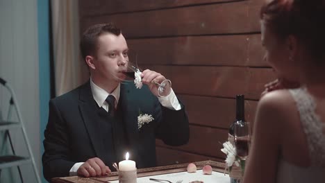 Young-man-and-his-beautiful-girl-drink-wine-during-dinner-in-a-restaurant-slow-motion-2