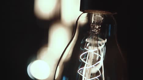 set-of-beautiful-little-glowing-lamps-in-a-dark-room-the-lamps-are-swinging-closeup-1