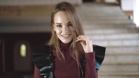 Portrait-of-a-young-beautiful-girl-dressed-in-leather-wings-close-up