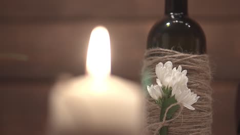 young-man-takes-a-bottle-of-wine-from-a-table-sitting-in-a-restaurant-close-up-slow-motion