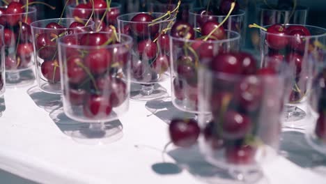 Fresh-cherries-in-transparent-glasses-on-the-table-on-the-beach-in-summer