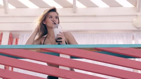 girl-on-summer-beach-touching-her-hair-drinking-cocktail-1