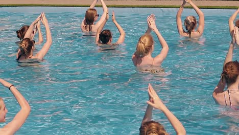 girls-are-engaged-in-water-aerobics-in-summer