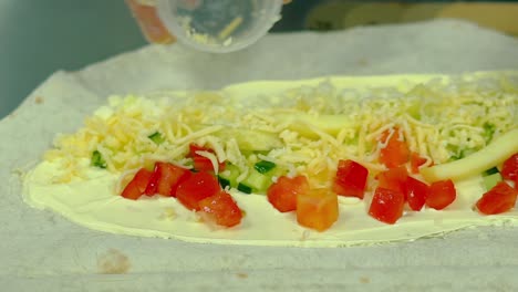 CU-Slow-motion-Cook-prepares-a-wok-with-fresh-vegetables-adds-cheese