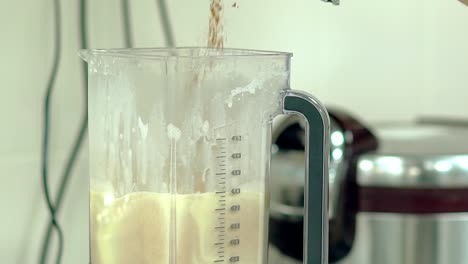 Cook-pours-cocoa-into-the-mixer