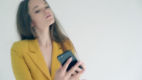 CU-Portrait-Young-beautiful-girl-making-selfie-uses-smartphone