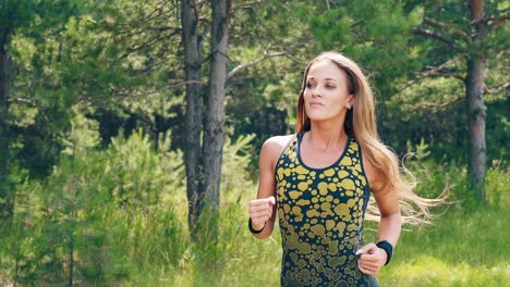 CU-Portrait-Young-girl-goes-in-for-sports-in-the-morning-runs-along-a-pine-forest-3