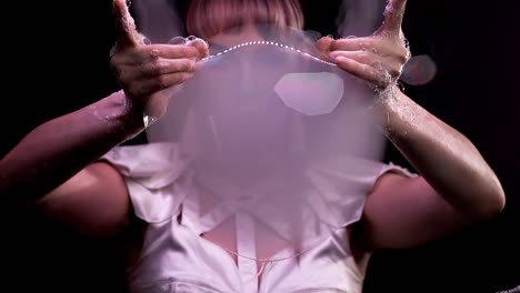 CU-Slow-motion-Tricks-with-soap-bubbles-The-girl-pierces-a-bubble-smoke-comes-out-of-it-from-two-sides