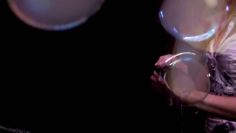 Close-up-Slow-motion-Tricks-with-soap-bubbles-The-girl-blows-bubbles-from-the-chimney