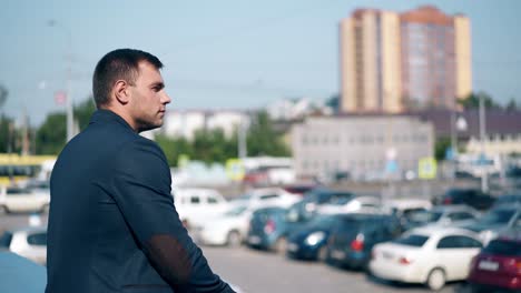 close-view-handsome-young-man-in-blue-jacket-against-city