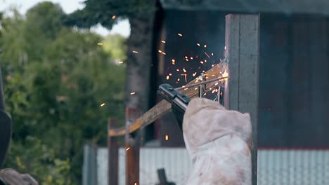 slow-motion-close-view-hand-with-welding-machine-at-fence