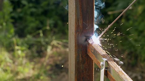 closeup-fence-building-with-using-welding-tool-under-sparks