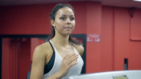 close-view-girl-turns-on-treadmill-and-starts-running