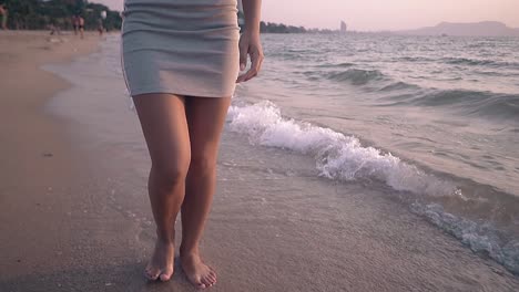 slim-lady-walks-along-beautiful-beach-at-ocean-slow-motion