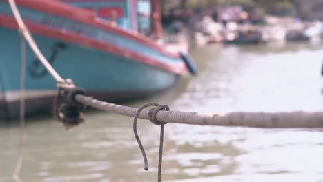 ship-rope-connects-fishing-boat-with-moor-close-view
