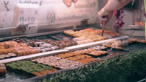 Thai-street-food-vendor-holds-plate-and-puts-salmon-sushi