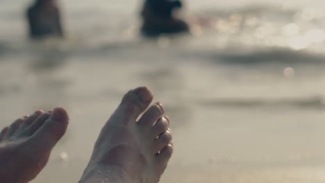 young-woman-feet-with-pedicure-against-blurred-ocean-closeup