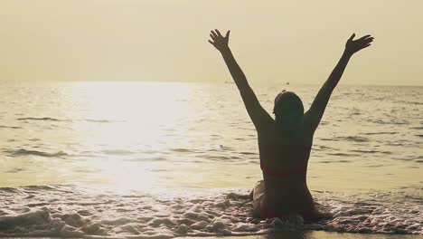 silhouette-of-woman-raising-hands-to-sun-on-tropical-beach