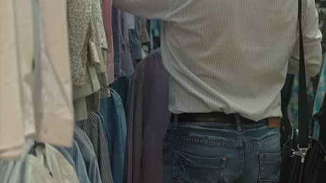 Man-chooses-a-shirt-in-the-mall-Slow-motion