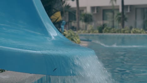 water-slide-with-running-flow-over-pool-closeup-slow-motion