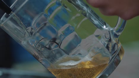 Young-man-pours-beer-into-a-mug-from-a-tap