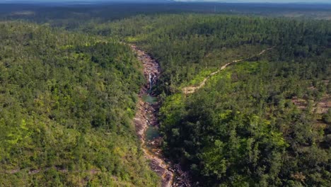 Aerial-over-the-creek-that-feeds-the-Big-Rock-Falls-in-the-Mountain-Pine-Ridge-Forest-Reserve,-Belize