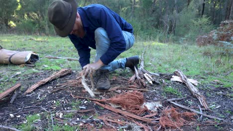 A-traditional-swagman-bushman-in-Australia-making-fire-with-a-bow-drill