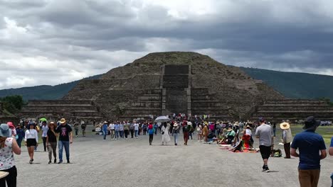 Slow-motion-shot-of-tourists-walking-towards-the-Teotihuacan-Pyramid-in-Mexico