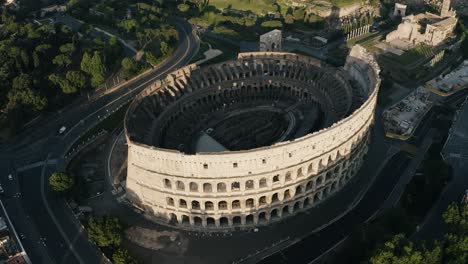 Drone-shot-of-the-Roman-Colosseum-surrounded-by-modern-streets