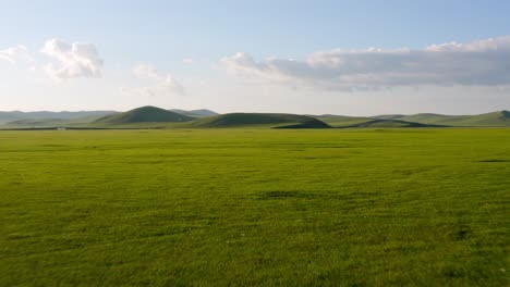 Drone-dolly-above-calm-peaceful-rolling-hills-on-mongolian-grassland-plains