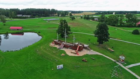 Aerial-Forward-approach-on-Munchausen-World-Museum-on-idyllic-latvian-landscape