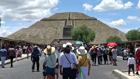 Slow-motion-shot-of-families-and-tourists-walking-towards-the-Teotihuacan-Pyramid