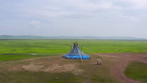 Drone-pulls-back-from-colorful-festive-cultural-art-display-on-mongolia-grassland