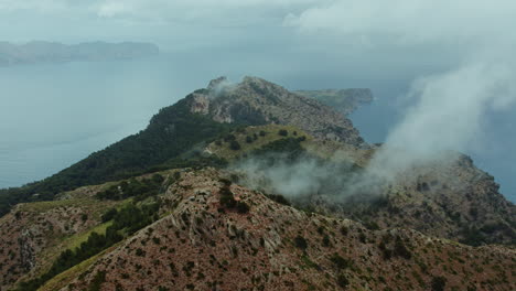 Aerial-View-Of-louds-In-The-Summit-Of-Talaia-d'Alcudia-Mountain-In-Mallorca,-Spain