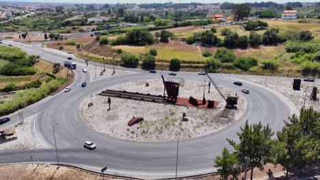 Static-drone-shot-of-a-roundabout-with-a-monument-in