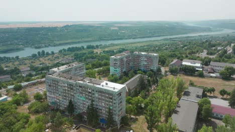 soviet-style-building-on-top-of-a-hill-in-the-city-of-rezina-with-a-view-of-the-Dnieper-river-roundabout-by-drone-in-Moldova-of-Republic