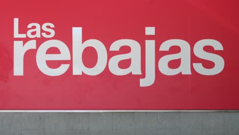 Customers-and-pedestrians-walk-past-a-large-banner-announcing-the-Summer-sale-season-outside-the-Spanish-biggest-department-store-El-Corte-Ingles-in-Spain