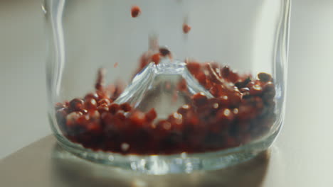 Close-up-shot-of-aromatic-dried-spice-seeds-filling-up-a-glass-jar