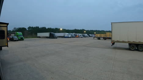 time-lapse-of-parking-at-a-large-truck-stop-as-the-sun-is-rising-and-the-truckers-are-starting-their-day