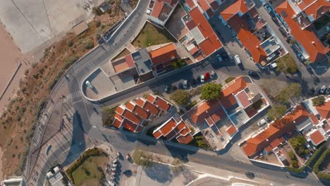 Top-down-bird's-eye-view-above-bright-orange-rooftops-in-albufeira-downtown,-portugal