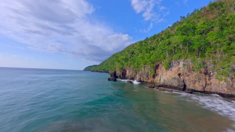 Beautiful-FPV-drone-flight-over-the-secluded-sandy-beach-of-Playa-Caleton-El-Valle,-Samana,-Dominican-Republic