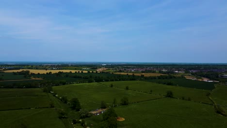 Aerial-wide-angle-pan-over-quaint-english-countryside-at-blue-hour-shade,-space-for-text